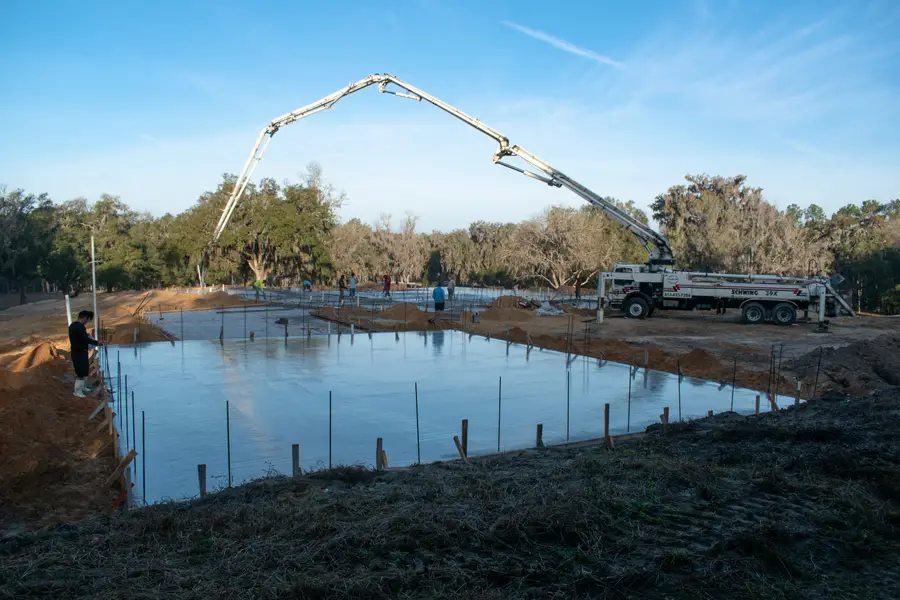 Total Concrete crew pouring a concrete foundation for a new home